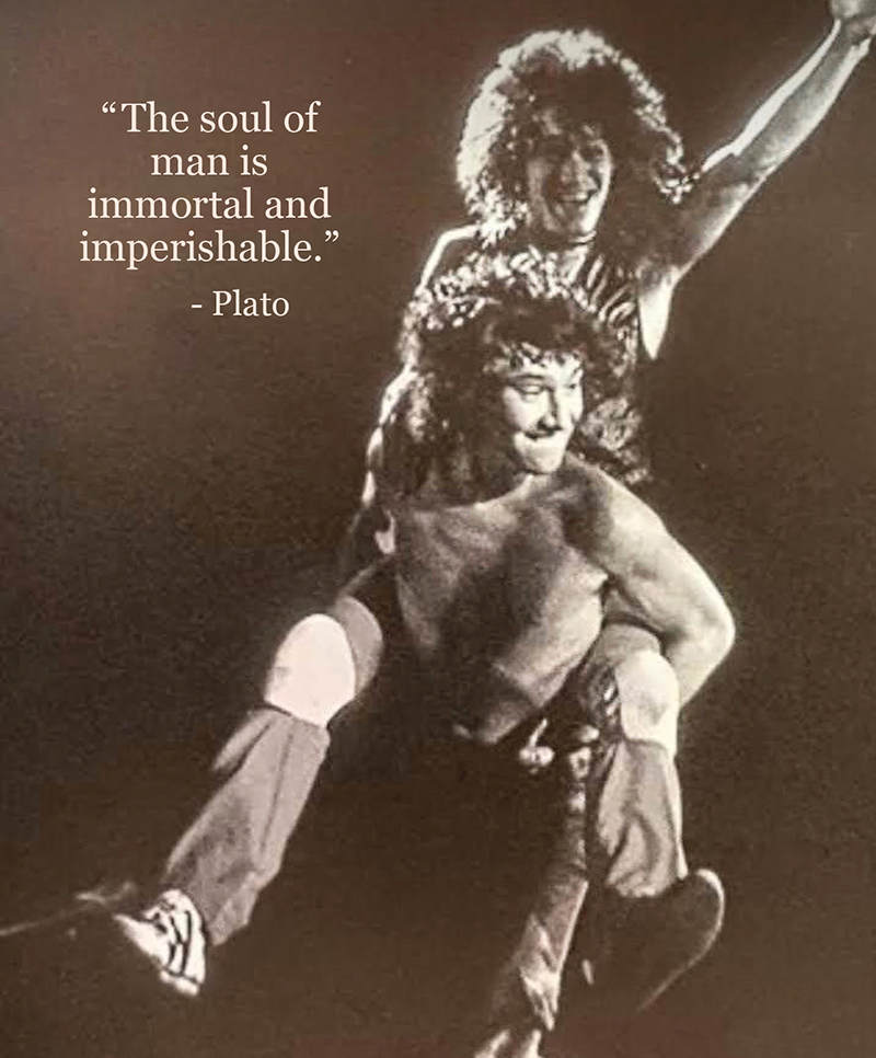 Alex carrying Eddie on his back on stage